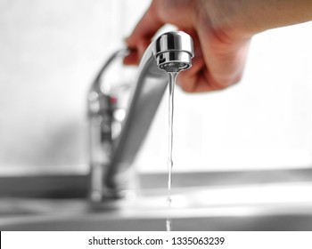 Hand Opens The Water Tap. Close Up.