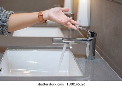 Hand Opens The Water Tap. Close Up.