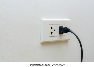 hand outlet Power saving Hand inserting electrical plug into outlet
