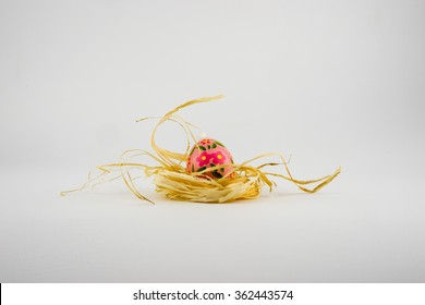 Hand painted Easter Eggs in a raffia nest.