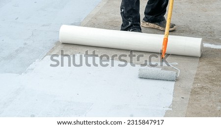 Hand painted gray flooring with paint rollers for waterproof, reinforcing net,Repairing waterproofing deck flooring. roof.                