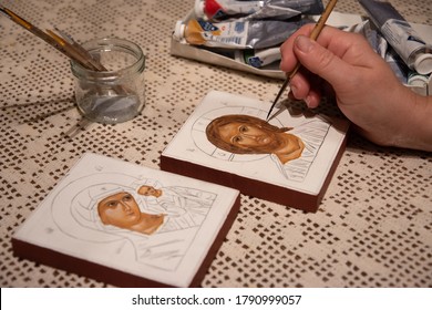 Hand painted orthodox icon during painting on piece of wood. A pair of wedding icons. Mother of God of Tenderness and Christ the Pantocrator