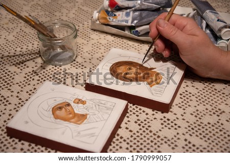 Hand painted orthodox icon during painting on piece of wood. A pair of wedding icons. Mother of God of Tenderness and Christ the Pantocrator