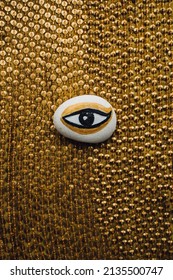 Hand Painted White, Gold, Black Evil Eye Rock In The Middle Of Gold Sequin Fabric. Ancient Egyptian Theme