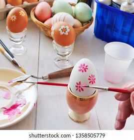 Hand painting Easter eggs with paintbrush. Easy design, fun craft for children.