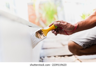 Hand painting outside wall with white color. - Powered by Shutterstock