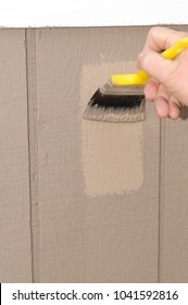 Hand Painting T111 Siding On A House, Ensuring To Get Paint In The Grooves