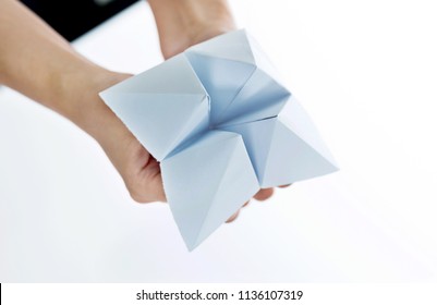 Hand In Paper Fortune Teller Isolated On White Background.