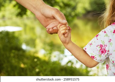 Hand Of Parent And Child