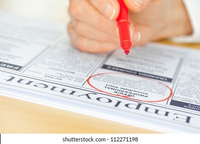 A Hand With A Pen Circling A Job In The Paper (focus On Pen Nib And Ad)