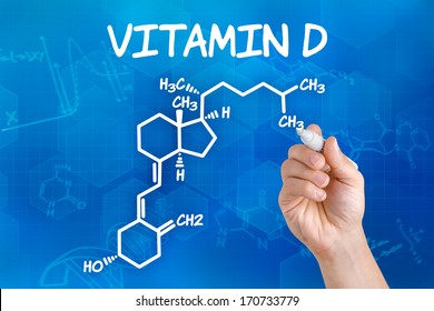 Hand With Pen Drawing The Chemical Formula Of Vitamin D