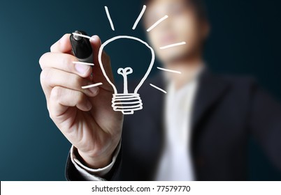 hand with a pen drawing light bulb - Powered by Shutterstock