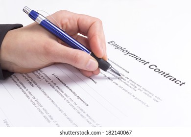 Hand With Pen And Employment Contract