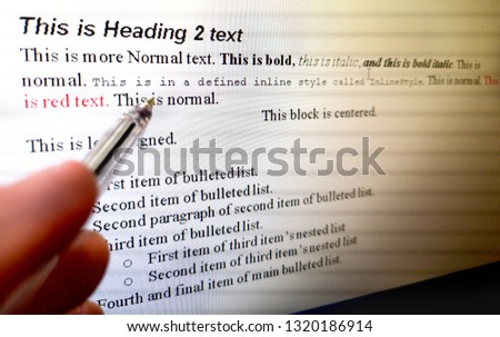 hand with pen indicate text formatting rules on word processor software on computer screen