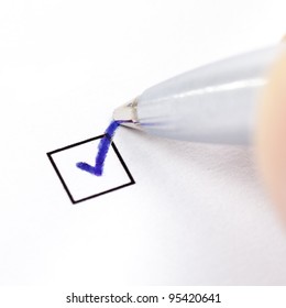Hand With Pen Marking A Check Box