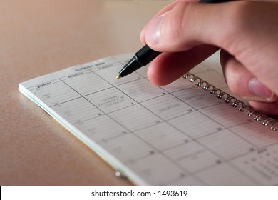 hand with pen on datebook - Shutterstock ID 1493619