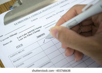 hand with pen over checklist form, man hands writing on paper - Shutterstock ID 455768638