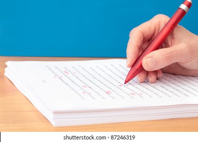 Hand With Pen Proofreading A Manuscript