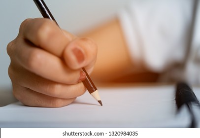 Hand and pencil pictures of students writing Education concept With copy space - Shutterstock ID 1320984035
