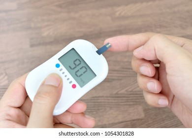 Hand Of People Check Diabetes And High Blood Glucose Monitor With Digital Pressure Gauge. Healthcare And Medical Concept