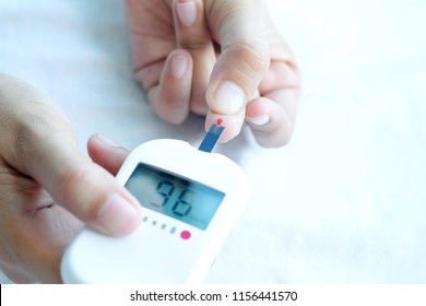 Hand Of People Check Diabetes And High Blood Glucose Monitor With Digital Pressure Gauge. Healthcare And Medical Concept