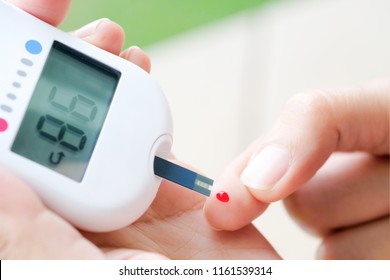 Hand Of People Check Diabetes And High Blood Glucose Monitor With Digital Pressure Gauge. Healthcare And Medical Concept