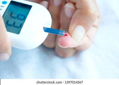 Hand Of People Check Diabetes And High Blood Glucose Monitor With Digital Pressure Gauge. Healthcare And Medical Concept