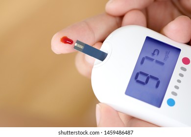 Hand Of People Check Diabetes And High Blood Glucose Monitor With Digital Pressure Gauge. Healthcare And Medical Concept