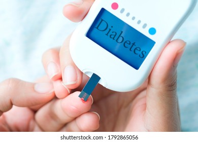 Hand Of People Check Diabetes And High Blood Glucose Monitor With Digital Pressure Gauge. Healthcare And Medical Concept