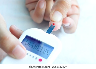 Hand Of People Check Diabetes And High Blood Glucose Monitor With Digital Pressure Gauge. Healthcare And Medical Concept