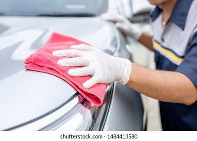 Hand Of People Using Red Cloth To Cleaning Body Of SUV Car. Cleaning Or Washing Car Concept