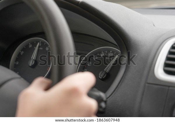 hand of a person driving a\
car