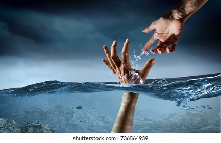 Hand of person drowning in water