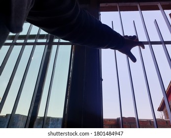 Hand Of A Person On Window Iron Roads. Sign Of Lockdown During Coronavirus Through Out The World. World Health Organisation Says To Be In Home. 