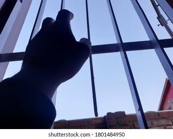 Hand Of A Person On Window Iron Roads. Sign Of Lockdown During Coronavirus Through Out The World. World Health Organisation Says To Be In Home. 