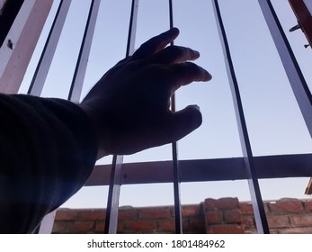 Hand Of A Person On Window Iron Roads. Sign Of Lockdown During Coronavirus Through Out The World. World Health Organisation Says To Be In Home. 