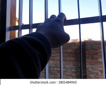 Hand Of A Person On Window Iron Roads. Sign Of Lockdown During Coronavirus Through Out The World. World Health Organisation Says To Be In Home. 