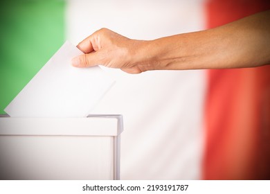 Hand person putting ballot in a box during elections in italy in front of flag - Shutterstock ID 2193191787