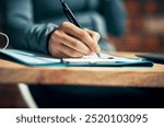 Hand, person and writing on clipboard on desk with filling application form or employment contact. Employee, tablet and pen with document or paperwork in file for signature for agreement in closeup