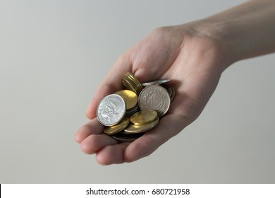 Hand with philippines coins in it at gray background