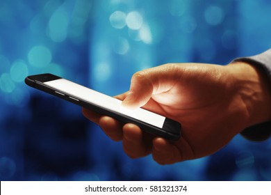 Hand with phone - Shutterstock ID 581321374