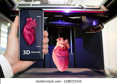 Hand with phone. Application for printing human organs in a 3D printer. 