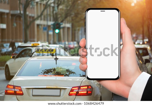 Hand and phone with white screen. The idea for\
the application by the order\
taxi