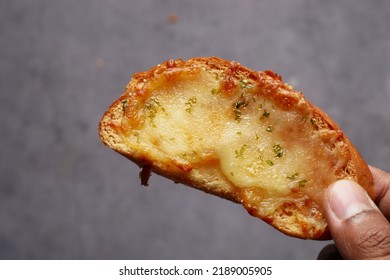 Hand Pick A Garlic Bread On A Plate 