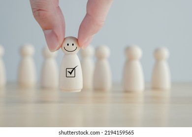 Hand Pick Happy Face Wooden Figure. Customer Service Rating Experience And Feedback Emotion And Satisfaction Survey. Human Resources Management Choosing Positive Attitude To Team Leader.