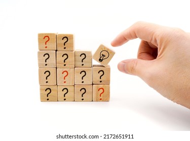 Hand Pick A Wooden Cube Block With Light Bulb Icon Out Of Question Mark Icon Represent Business Concept Of Thinking To Find Answer Or Solution To Solve Problem With Idea And Creativity