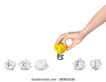 The hand picked bright crumpled paper out of some simple crumpled papers. The concept of selecting the best ideas. - Shutterstock ID 380842630