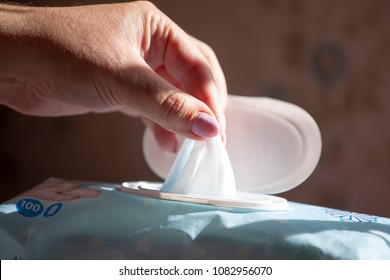 Hand picked a wet wipes in package box, Wet wipes in a woman's hand