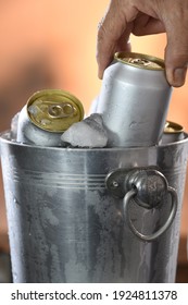 Hand Picking Beer Can From Cooler Tank