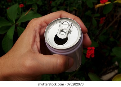 Hand Picking A Can In Garden